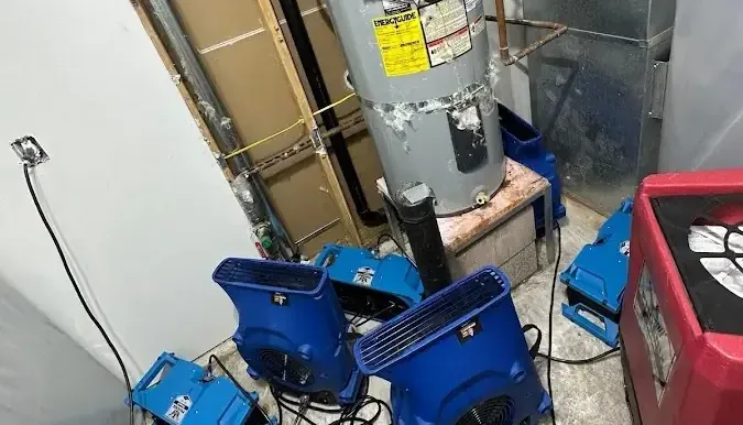 Air movers around a water heater during drying